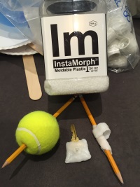 InstaMorph moldable plastic shown with fabrications including two adapted pencils and an adapted key. All were made to be more grippable, one using a tennis ball.