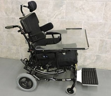 Manual wheelchair with head support, tilt, and tray. 